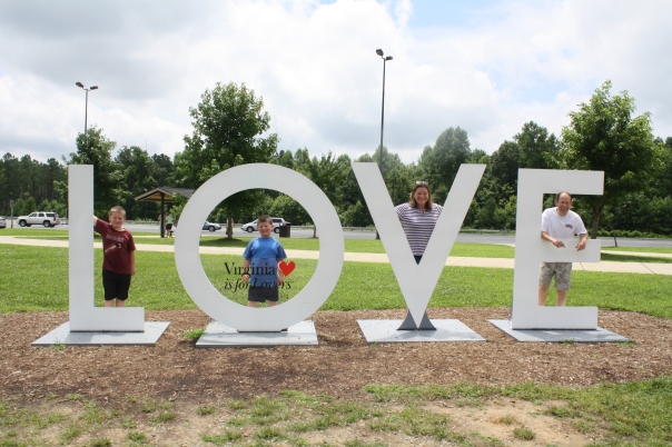 Our family at the outset of Harrison Holiday 2013 posing at the New Kent LOVE WORKS sign.